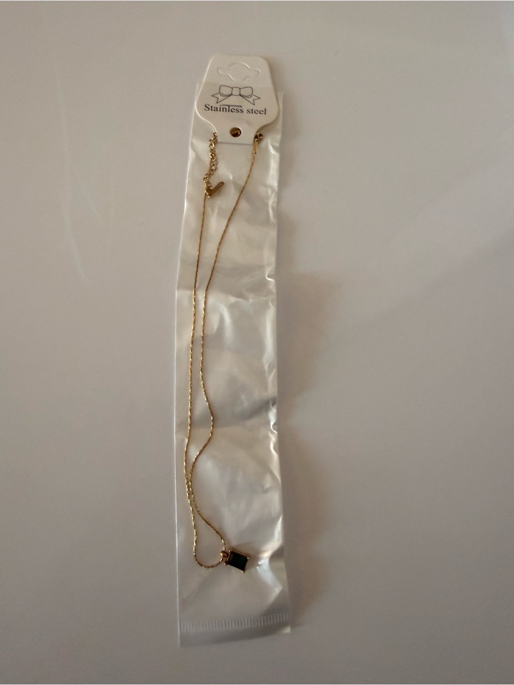 Delicate Gold-Tone Necklace with Black Rectangular Pendant